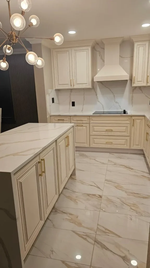 Custom kitchen with light wood cabinets, island, and pendant lights — high-end kitchen design by Romero Design in Indianapolis, Indiana